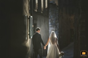 At Borgo di Cetona, Tuscany, the couple poses for a portrait amidst the breathtaking Tuscan landscape, capturing the essence of romance and beauty.